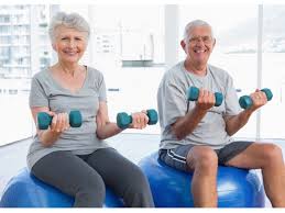 senior citizens on exercise balls with weights